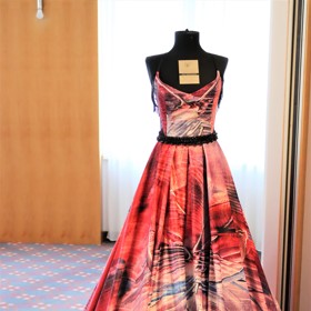 Šaty jsou z dílny Hannellen návrhářky Hanky Mrázové. Vznikají tiskem na saténovou látku.