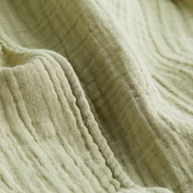 Detail mušelínového materiálu, typický svým prolamovaným, mačkaným, keprovým vzhledem.