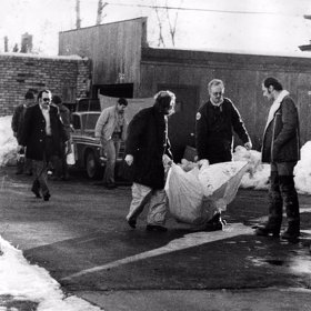 Policie vynáší tělo z Gacyho domu.