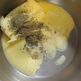 Máslo s majoránkou rozpusťte ve vodní lázni.