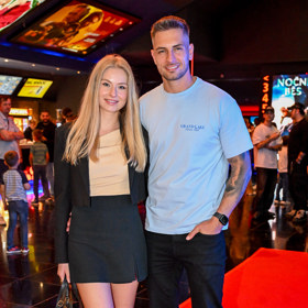 Influencer Matěj Quitt s přítelkyní, která oblékla černou minisukni a k ní nazula bílé tenisky.