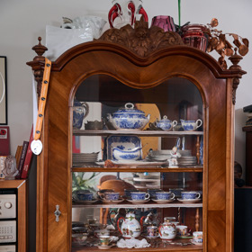 Starožitný skleník s porcelánem a sklenkami.