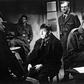 Na snímku z filmu Král Šumavy jsou herci (zleva): Ilja Prachař, Jiří Vala, Jiří Holý uprostřed, Radovan Lukavský a Ferdinand Krůta.